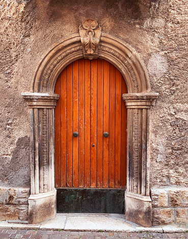 Old wooden door in the medieval city in Italy