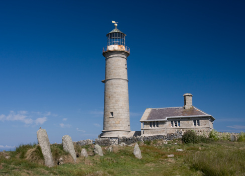 The Old Lighthouse on Lundy Island showing four Celtic inscribed stones dating from the 5th or 6th century in the foreground