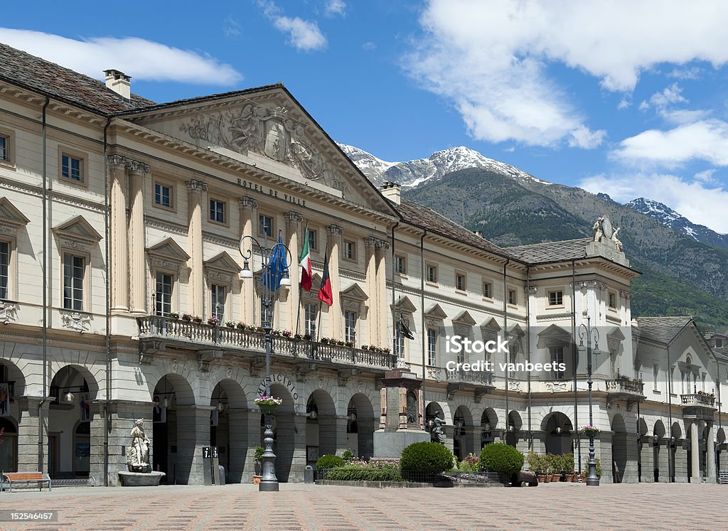 Town hall of Aosta in Italy. Town hall of Aosta in Italy. With text in French and Italian: Hotel de Ville and Municipio.At the background mountains with snow. Valle D'Aosta Stock Photo