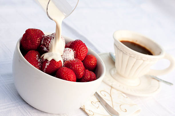 Strawberries with cream and coffee stock photo