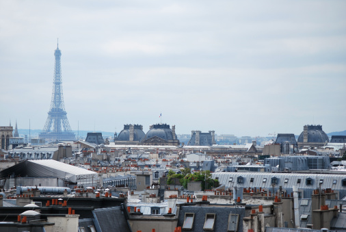 La Tour Eiffel looking over colorful Parisian roofs