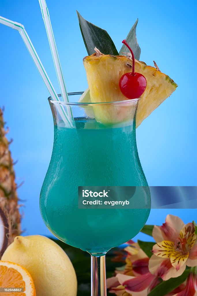 Most popular cocktails series - Blue Hawaiian Blue Hawaiian cocktail surrounded by tropical fruits. Rum, pineapple juice, coconut milk and blue curacao garnished with slice of pineapple and maraschino cherry. Most popular cocktails series.. Alcohol - Drink Stock Photo