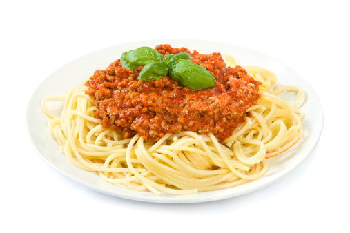 A whole plate of spaghetti bolognese isolated on white.