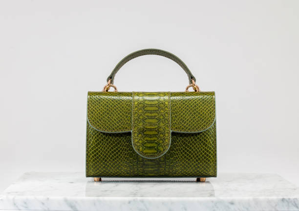 高級レディースバッグ。白い背景に高級緑の革製ハンドバッグ