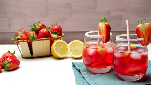 Cold strawberry drink Cold strawberry drink with fresh strawberries and lemon on wooden background strawberry crush stock pictures, royalty-free photos & images