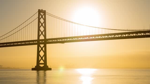Sun Rises Behind The Bay Bridge in San Francisco