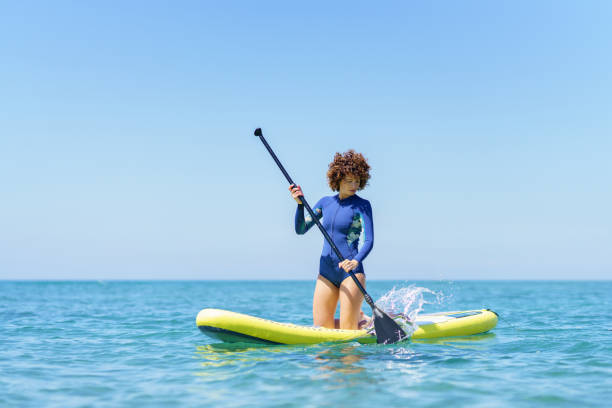 istock Woman with paddle on paddleboard in sea 1525684612
