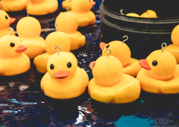 istock Yellow Plastic Ducks At A Fairground 'Hook A Duck' Game 1525794938