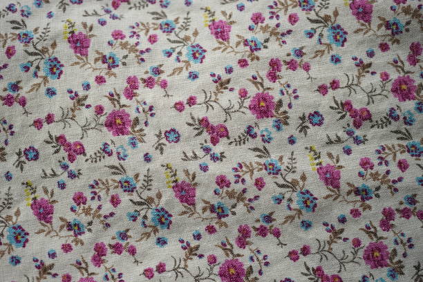 istock Cute linen fabric with a floral pattern, pink and blue flowers on a beige material 1525820312