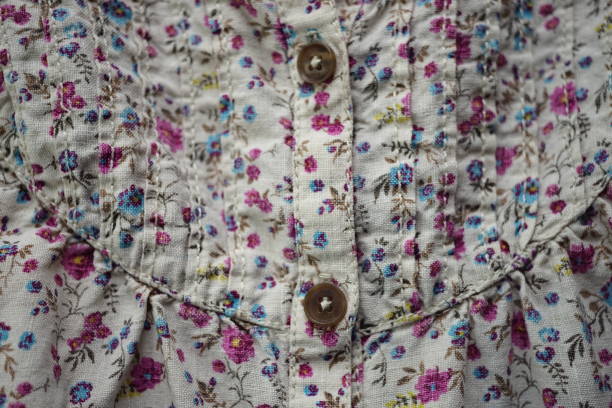 istock Thick linen fabric with a cute floral pattern, pink and blue flowers on a beige material 1525820314