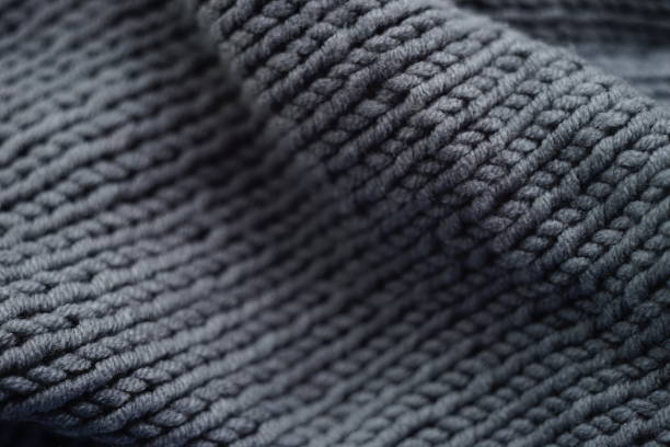 Knitted grey background, gray scarf cozy pattern Knitted grey background, gray scarf cozy pattern. wool stock pictures, royalty-free photos & images