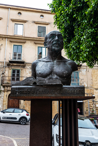 Agrigento, Italy - May 8, 2023: Statue of Luigi Pirandello in front of the Luigi Pirandello Theater in the old town of Agrigento, Sicily, Italy