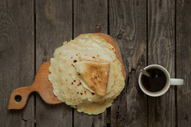 istock stack of fried pancakes on a wooden table and a cup with coffee in the kitchen for breakfast 1525941485