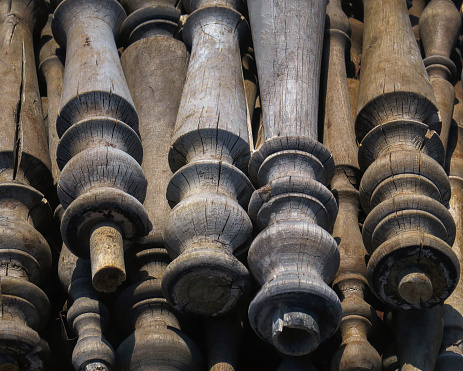close up of a retail display of a pile of old and weathered wooden table legs and posts, for sale at a salvage yard. Long Island, New York