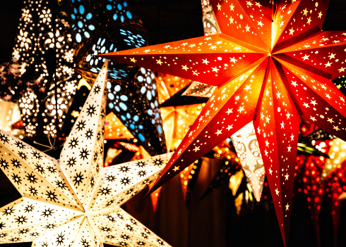 Colourful illuminated Christmas star decorations at Bath Christmas Market.