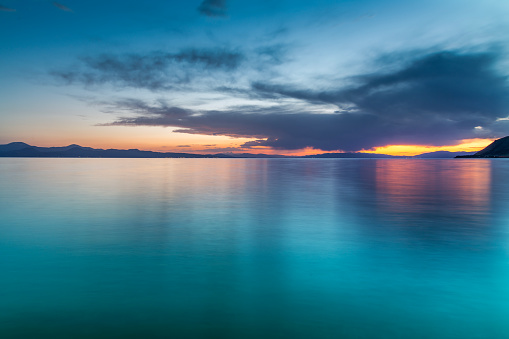 Beautiful sea landscape after sunset with blue clouds.