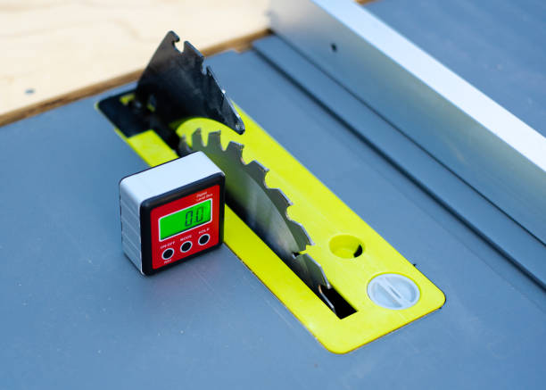 istock Digital level box inclinometer showing level 0-degree angle with magnetic base attaches to metal surface of brand-new table saw 1526089914