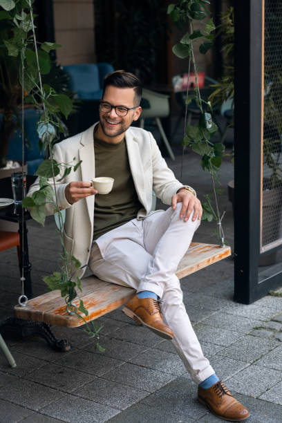 istock Man sitting on a swing in outdoor Cafe 1526200278