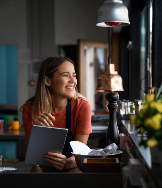 Beautiful smiling female managing business in bakery