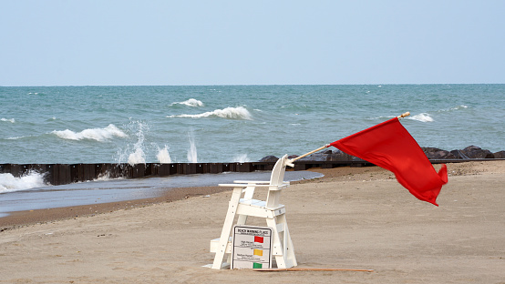A red flag. Warning sign on the beach