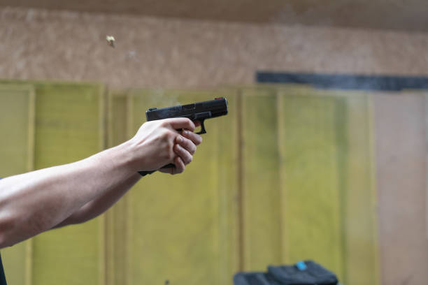 istock Shooting from a pistol in a shooting range, recoil from a shot from a weapon. 1526423004