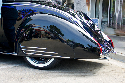 Rear fender side view of a sleek vintage auto