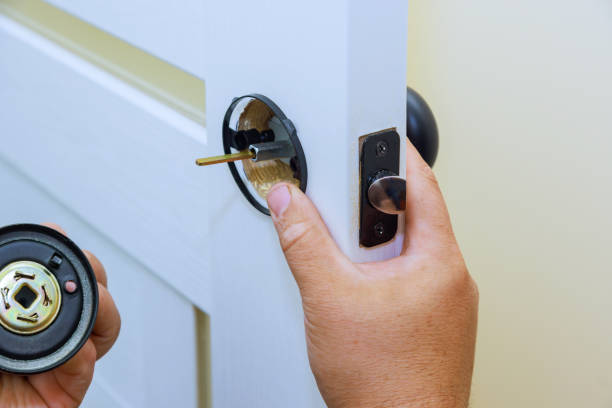 istock With worker attaches a lock to new interior door. 1526473356