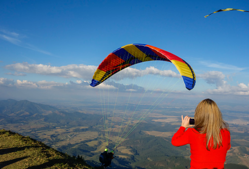 Santo Antonio do Pinhal, SP - Paraglider taking off from Pico Agudo peak, with spectators