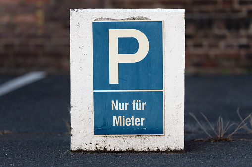 white-blue sign with german lettering -parking for tenants only-.