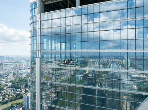Workers overhauling high-rise glass