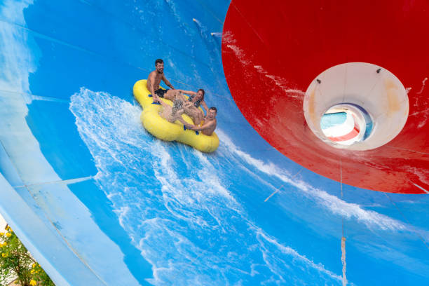 istock Friends having fun sliding in a big water slide 1526689738