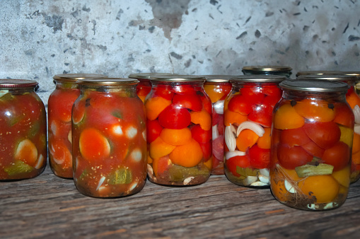 Jars of a variety of pickled vegetables . Canned and preserved foods. Preserves