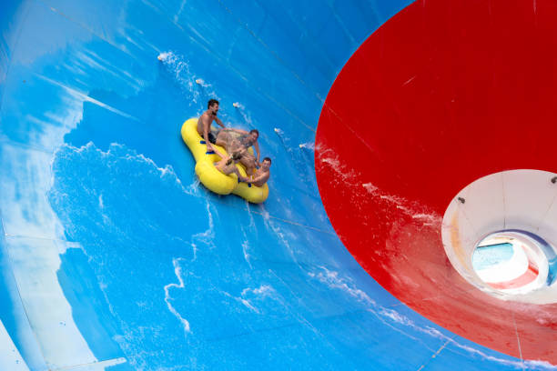 istock Friends having fun sliding in a big water slide 1526737574