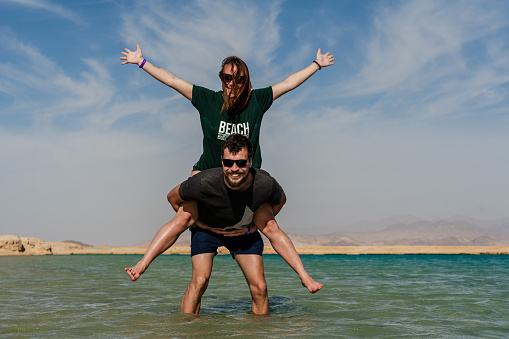 Happy couple posing at lake in desert of Ras Mohammed National Park. Egypt