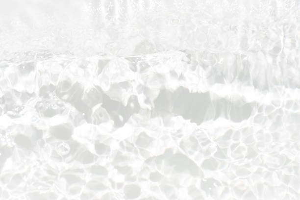 istock White water with ripples on the surface. Defocus blurred transparent white colored clear calm water surface texture with splashes and bubbles. Water waves with shining pattern texture background. 1526759010