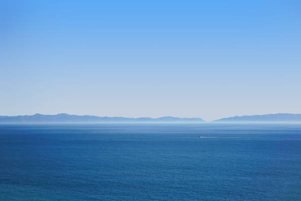 Hazy Ocean view with a boat in the distance stock photo