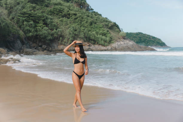 istock Beach Bliss: Woman in Bikini Enjoying a Tranquil Walk on the Shore 1526872677