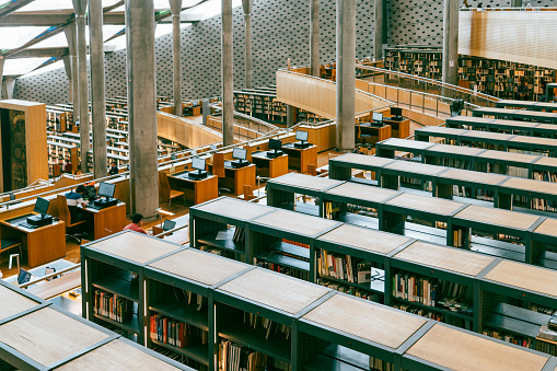 Alexandria,Egypt,06/21/2023:locals studying at the grand library of Alexandria. Book shelves can be seen in the background.Alexandria was once the largest library with most collection of books in the world back to ancient Egypt.