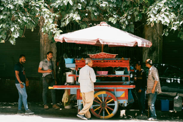 Alexandria, Egypt - June 21, 2023: Locals enjoying coffee and sunshine on street in Alexandria, which once was one of the greatest cities in ancient world.