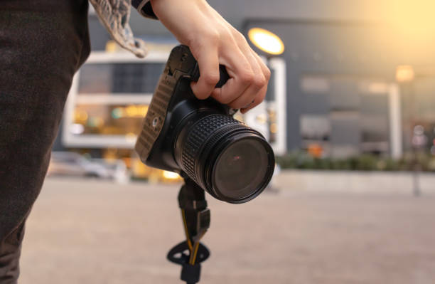 istock Hand holding professional photo camera. Copy space. 1526905974