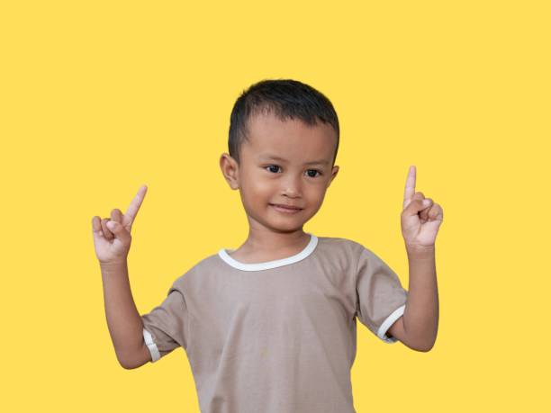istock Happy asian boy pointing up 1526975654