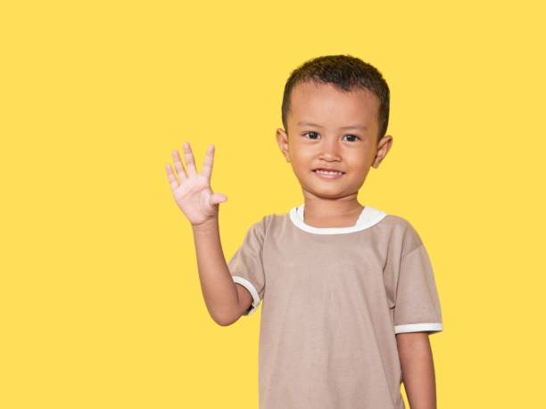 istock Image of Asian boy posing on yellow background 1526975692
