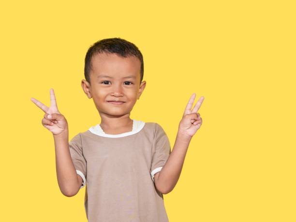 istock Image of Asian child posing on yellow background 1526979441
