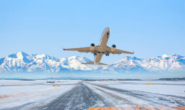 istock Commercical white airplane fly up over take-off runway the (ice) snow-covered airport 1526989214