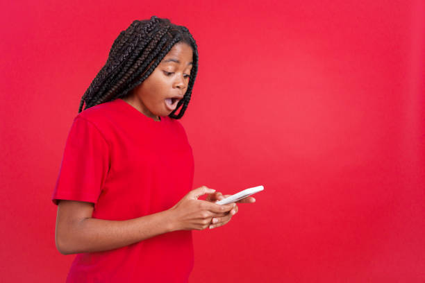istock Surprised african woman looking at the mobile 1527017351