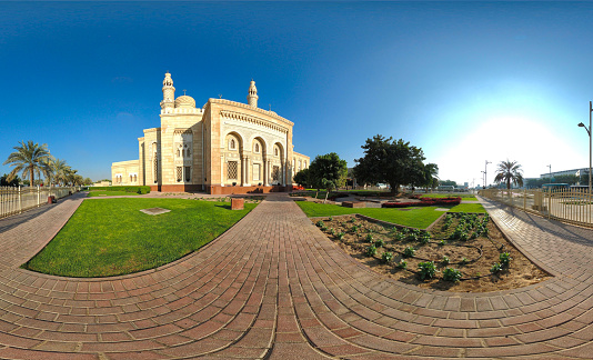 People sit in front of the Great Mosque of Asmara in downtown Asmara, Eritrea, East Africa on a sunny day.