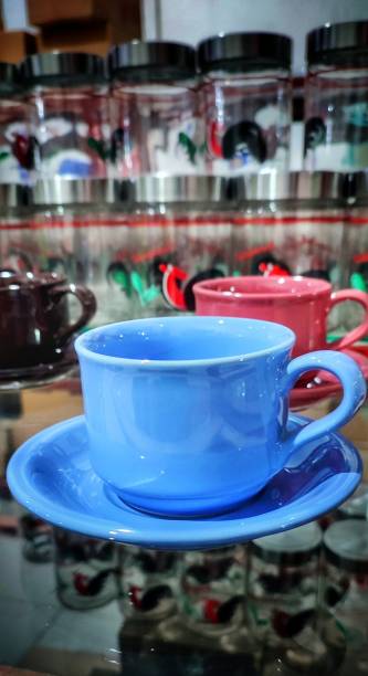 istock a set of shiny light blue ceramic cups in a pottery shop window 1527032442