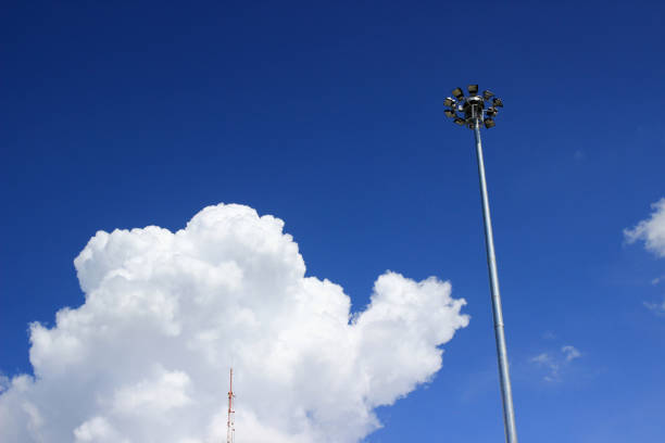 Urban progress. Modern electric pole against a scenic blue sky with clouds.Power and connectivity in the city