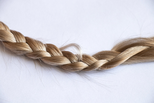 blond hair braid on an isolated background close-up