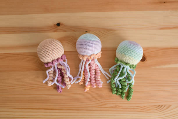 istock Handmade crocheted octopus on a wooden background. handmade. 1527115257